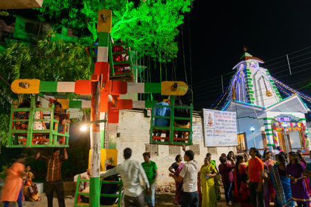 HOWRAH,WEST BENGAL,INDIA -APRIL 15TH, 2018 : Children are riding on Nagordola- a traditional amusement ride to celebrate the first day of bengali new year. Gajan or Charak is a popular Hindu festival.の写真素材