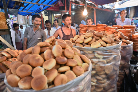 KOLKATA, WEST BENGAL, INDIA - MAY 27 2019 : Sellers selling local bakery made biscuits being sold in Jakaria or Zakaria street , near Nakhoda Mashid in Kolkata. Famous fast food zone for all.のeditorial素材