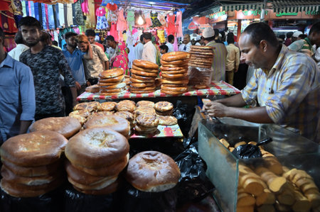 KOLKATA, WEST BENGAL, INDIA - MAY 27 2019 : Various sized fresh baked breads are stcked up for sale as street food in Zakaria street.のeditorial素材