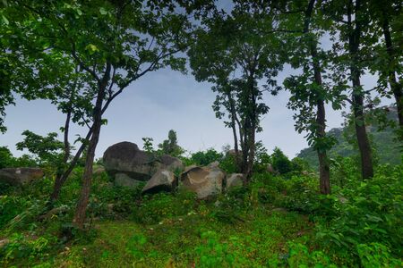 Mayur Paharh is a small hill of Purulia., West Bengal, India. The beautiful rocks are rain soaked , with blue monsoon sky in the background signalling rain is approaching. Monsoon season.の写真素材