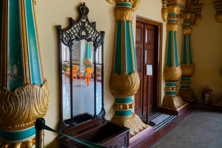 Mysore, Karnataka, India - November 25th 2018 : Beautiful Belgium glass mirror with oak veneered dressing table, inside the royal Mysore Palace. Gold used on gilded columns.のeditorial素材