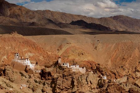 Ruins and Basgo Monastery surrounded with stones and rocks of Himalayan mountains , Leh, Ladakh, union territory, India. Play of light and shadow on backgound mountains.の写真素材