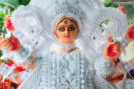 Kolkata, West Bengal, India - 7th October 2018 : Clay idol face of Goddess Durga, with white dress for Durga Puja festival. Biggest festival of Hinduism, celebrated all over the world.のeditorial素材
