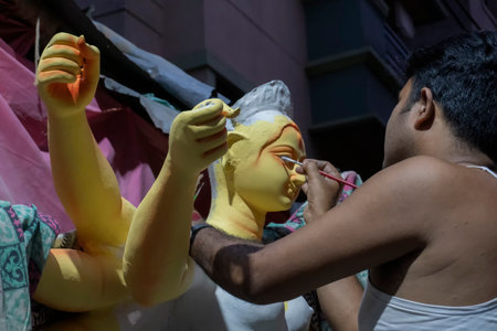 Kolkata, West Bengal, India - 7th October 2018 : Artist drawing eyes of Goddess Durga on her clay idol, for Durga Puja festival. Biggest festival of Hinduism, celebrated all over the world.のeditorial素材