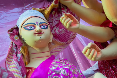 Kolkata, West Bengal, India - 7th October 2018 : Clay idol face of Goddess Saraswati, under...