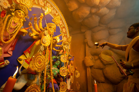 Kolkata, India - October 16, 2018 : Young Hindu Priest worshipping Goddess Durga with sacred lamp...