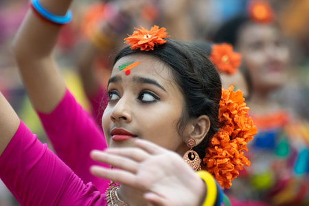 KOLKATA , INDIA - MARCH 1, 2018 : Portrait of girl dancer, dressed in sari (traditional Indian dress) and Palash flowers (Butea monosperma) make up, dancing at Dol (in Bengali) or Holi (in Hindi).のeditorial素材