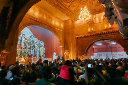Kolkata, India - October 18, 2018 : Goddess Durga idol being worshipped inside decorated Durga Puja pandal, shot at colored light at night. It is the biggest festival of Hinduism.のeditorial素材