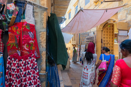 Jaisalmer, Rajasthan, India - October 13, 2019 : Colourful ladies clothes are displayed for sale to tourists in market place Inside Jaisalmer Fort, in the morning. Popular UNESCO world heritage site.のeditorial素材
