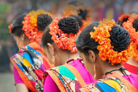 Kolkata, India - 1st March, 2018 : Girl dancers dressed in sari, traditional Indian dress with Palash flowers, Butea monosperma, make up, dancing at Holi festival. Arrival of Spring in India.のeditorial素材