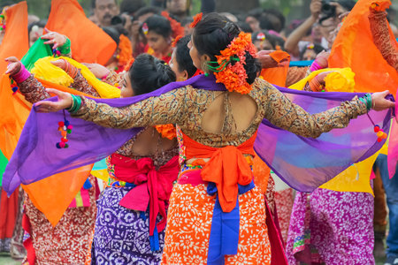 Kolkata, India- 1st March 2018: Girl dancers,dressed in colourful sari (traditional Indian dress) and Palash flowers (Butea monosperma) make up,dancing at Dol (in Bengali) or Holi (in Hindi) festival.のeditorial素材