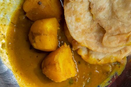 Top view of kachori with alur dom, a famous Bengali dish. Kochuri, kachori of kachauri is a spicy snack and generally served with potato curry called alur dom. Popular street food. Street food, India.の写真素材