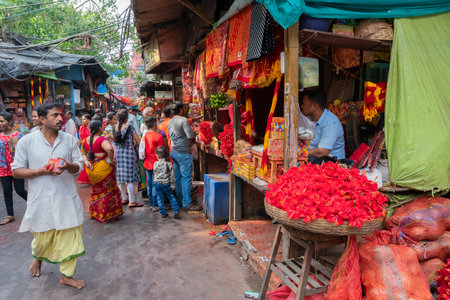 Kolkata, West Bengal, India - 15th April 2019 : Hibiscus flowers, red saris and other worship matetials are being sold to Bengali devotees in Kalighat market. Image shot at Kalighat, Bengali New year,のeditorial素材