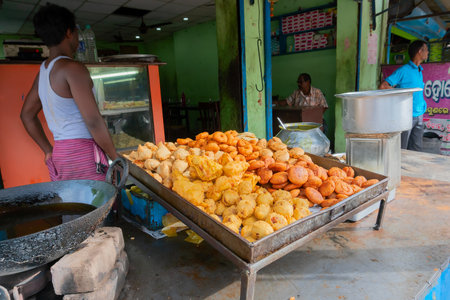 Cuttack, Odisha, India - 24th July 2019 : Piiyaji, bara, aloo chop etc, are being sold by cart puller called thelawalla , street foods of Odisha.のeditorial素材