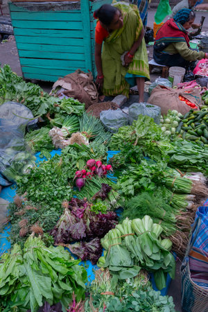 Kolkata, West Bengal, India - 16th December 2018 : Vegetables are being sold roadside. Young woman is selling them to customers in a market in Territy Bazar, Kolkata.のeditorial素材
