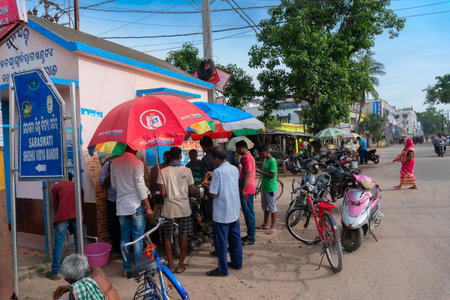 Cuttack, Odisha, India - 24th July 2019 : View of road of Cuttack city, roadside food stalls serving customers.のeditorial素材