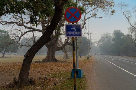 Kolkata, West Bengal, India - 23rd January 2020 : Road side signboard of Kolkata Police, called KP, allerting vehicle drivers about CCTV surveillance. Shot at city road in winter morning.のeditorial素材