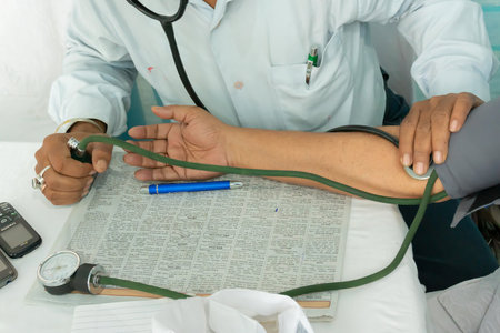 Kolkata, West Bengal, India - 25th February 2018 : Indian Doctor checking blood pressue of a patient with medical instruments.のeditorial素材