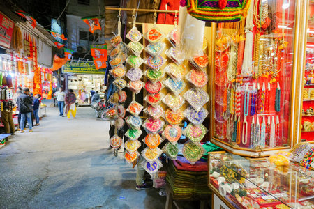 Haridwar, Garhwal, India - 3rd November 2018 : Auspicious yellow merchandise hanging for sale. At...