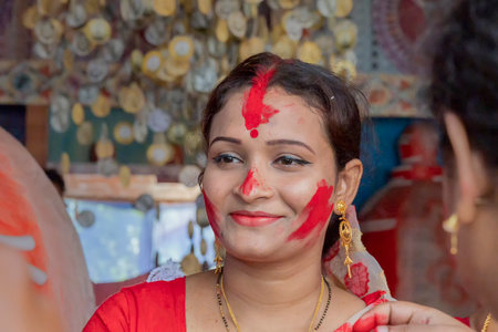 Kolkata,West Bengal,India - 9th October 2019 : Face of Bengali married woman in sindoor or sindur khela, traditional ritual of applying vermilion to faces,immersion of Goddess durga in Vijaya Dashami.のeditorial素材