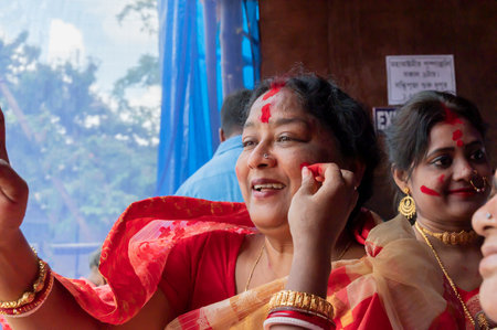 Kolkata,West Bengal,India - 9th October 2019 : Bengali married women face in sindoor or sindur khela, traditional ritual of applying vermilion to faces, immersion of Goddess durga in Vijaya Dashami.のeditorial素材