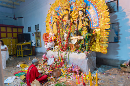 Kolkata, West Bengal, India - 6th October 2019 : Hindu purohit uttering holy sanskrit shlokas for...