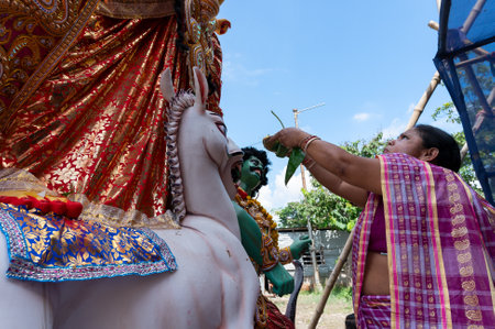Howrah, West Bengal, India- 8th October 2019 : Vijayadashami, married Bengali Hindu woman offering sweets to Goddess Durga and praying to Her. Durga puja festival traditional ritual, before immersion.のeditorial素材