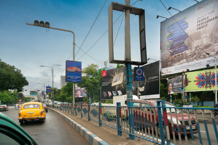 Kolkata, West Bengal, India - 6th August 2019 : Busy city traffic of Kolkata road. The road divider with street lights.のeditorial素材