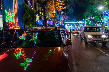 Park Street,Kolkata, India - 12th November 2020 : Reflection of decorated Diwali light on parked car bonnet, diwali lights for the occassion of Diwali or deepabali. It is the festival of light.のeditorial素材