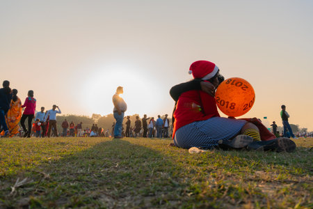 Kolkata, West Bengal, India - 25th December 2017 : Lovers hugging, Christmas at Kolkata maidan with setting sun in background. It is a place for many civilians to spend in winter afternoon.のeditorial素材