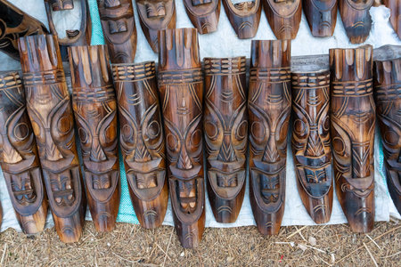 Wooden masks or tribal masks, wall hanging handicrafts, on display during the Handicraft Fair in Kolkata - the biggest handicrafts fair in Asia.の写真素材