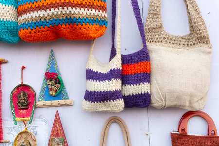 Colorful handmade bags on display , handicraft products being sold at hastashilpomela or handicrafts...