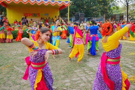 Kolkata, West Bengal, India - 9th March 2020 : Group dancing of Bengali girls dressed in colorful Indian dresses, at Dol utsab or Holi festival. Celebration of arrival of spring in India.のeditorial素材