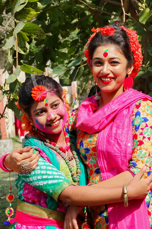 Kolkata, India - March 9th, 2020 : Beautiful young girls with spring festive make up , smiling at Holi festival, known as Dol (in Bengali) or Holi (in Hindi) celebrating arrival of Spring.のeditorial素材