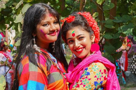 Kolkata, India - March 9th, 2020 : Beautiful young girls with spring festive make up , smiling expression at Holi festival, known as Dol (in Bengali) or Holi (in Hindi) celebrating arrival of Spring.のeditorial素材