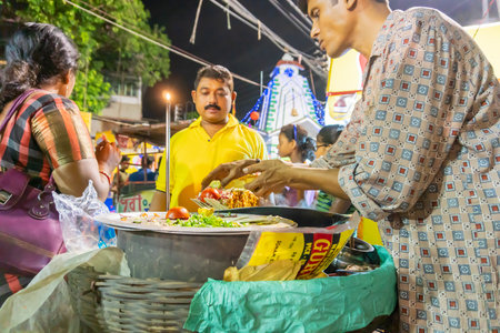 Howrah, West Bengal, India - April 14th 2019 : Street vendor serving chotpoti , a roadside Indian...