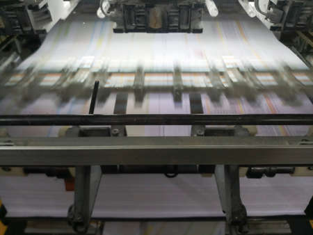 A modern four colour printing machine running in high speed. Shot at Kolkata, West Bengal, India.