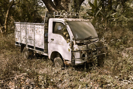 Howrah, West Bengal, India - 15th March 2021 : Old truck left to rust amidst nature. Sepia color.のeditorial素材