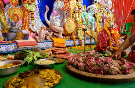 Howrah, West Bengal,India - 25th October 2020 : Various fruits, bengali foods, flowers, sweets and saris, are offered to Goddess Durga , being worshipped during Durga puja. The biggest Hindu festival.のeditorial素材