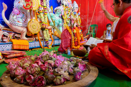 Howrah, West Bengal, India - 25th October 2020 : Goddess Durga is being worshipped by Hindu priest, uttering sanskrit shlokas. Sondhipujo aarti at Ashtami. Puja is Corona pandemic.のeditorial素材
