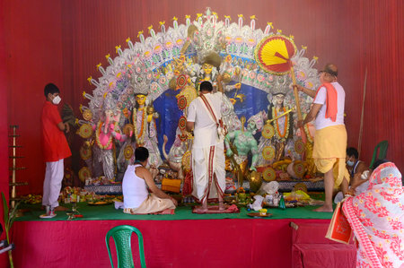Howrah, West Bengal, India - 25th October 2020 : Goddess Durga is being worshipped by Hindu priest with holy chamor during aarti.のeditorial素材