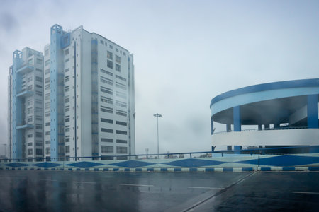 Howrah, West Bengal, India - 4th August 2020 : Shot through raindrops falling on car windshield glass, Nabanna building , state administrative office. Monsoon stock image.のeditorial素材