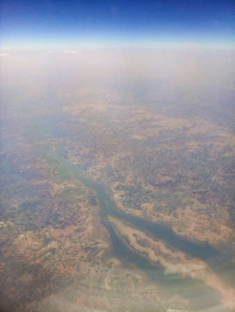 Aerial river and riverbed landscape of India, with nice white clouds in the atmosphere, image shot in the sky from aeroplane. Nature stock image.の写真素材