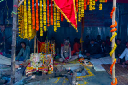 Blurred image of Kolkata, West Bengal, India. Indian Hindu Sadhu inside his tent, decorated wiith...