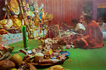 Howrah, India - October 15th, 2021 : Priests performing Sandhi Puja, the sacred juncture of Ashtami,...