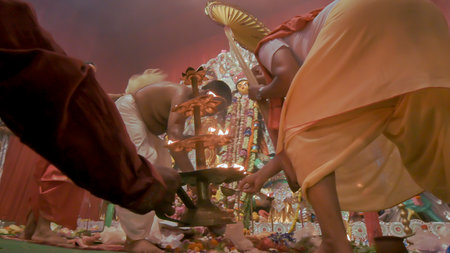 Howrah, India - October 15th, 2021 : Devotee lighting up 108 lamps during Sandhi Puja, the sacred...