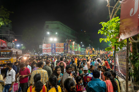 Kolkata, West Bengal, India - 12th October 2021 : Traditional Durga Puja at city of joy, UNESCO Intangible cultural heritage of humanity. Devotees rushing to visit famous Puja pandal at night.のeditorial素材