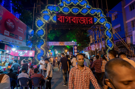 Kolkata, West Bengal, India - 12th October 2021 : Huge welcome gate for Bagbazar Durga Puja, UNESCO Intangible cultural heritage of humanity. Devotees rushing to visit famous Puja pandal at night.のeditorial素材