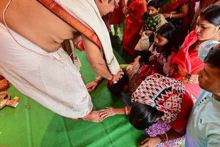 Howrah, West Bengal, India - 14th October 2021 : Hindu Purohit blessing devotees during pushpanjali puja to Goddess Durga, sacred ritual to worship the Goddess.のeditorial素材