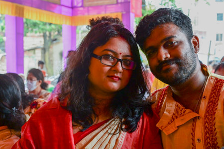 Howrah, West Bengal, India - 14th October 2021 : Newly married romantic couple posing for camera inside Durga Puja pandal. Durga Puja festival.のeditorial素材
